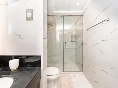 a bathroom with a glass shower and a toilet at Elegant Two Bedroom Apartment with Large Balcony and Panoramic Downtown Skyline & Boulevard Views by Luxury Space in Dubai