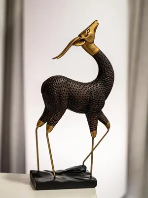 a metal animal statue of a giraffe on a table at Elegant Two Bedroom Apartment with Large Balcony and Panoramic Downtown Skyline & Boulevard Views by Luxury Space in Dubai