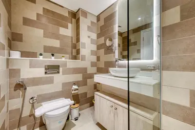 a bathroom with a toilet and a sink at Beachfront Studio Right by Nakheel Mall in Dubai