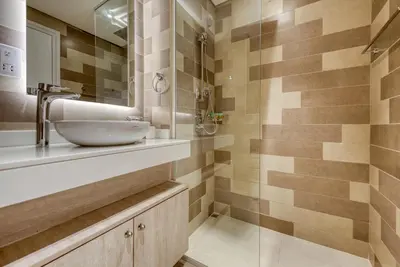 a bathroom with a sink and a shower at Beachfront Studio Right by Nakheel Mall in Dubai