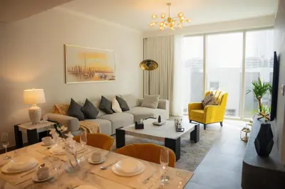 a living room with a couch and a table at Luxury 2 Bedroom Poolside Haven in Dubai Creek Harbour in Dubai