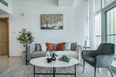 a living room with a couch and a table at ShoresInn - Marvelous Marina View In Dubai in Dubai