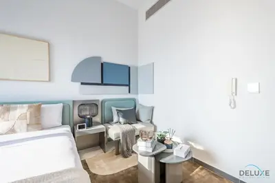a living room with a bed and a couch at Appealing Studio in MAG EYE 890, Mohammad Bin Rashid City by Deluxe Holiday Homes in Dubai