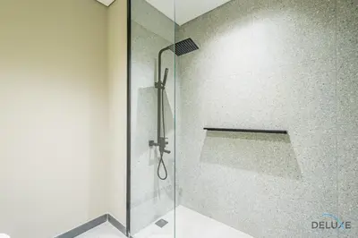 a shower with a glass door in a bathroom at Appealing Studio in MAG EYE 890, Mohammad Bin Rashid City by Deluxe Holiday Homes in Dubai