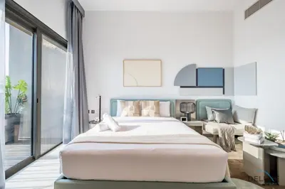 a bedroom with a large bed and a living room at Appealing Studio in MAG EYE 890, Mohammad Bin Rashid City by Deluxe Holiday Homes in Dubai