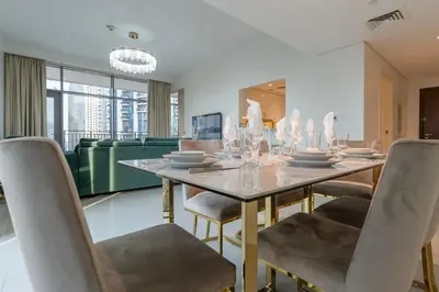 a dining room with a table and chairs at Beautiful 2BR I Heart of BLVD I Downtown Dubai in Dubai