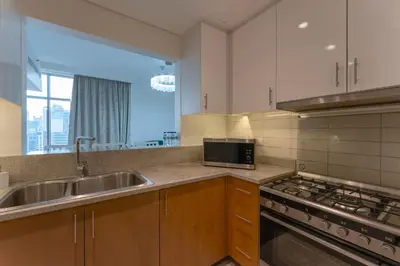 a kitchen with a sink and a stove at Beautiful 2BR I Heart of BLVD I Downtown Dubai in Dubai