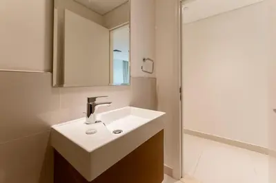 a bathroom with a white sink and a mirror at Beautiful 2BR I Heart of BLVD I Downtown Dubai in Dubai