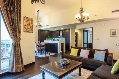 a living room with a couch and a table at Luxury loft apartment downtown in Dubai