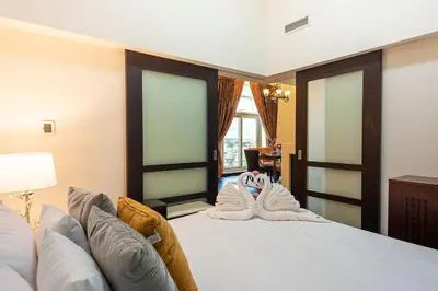 a bedroom with a bed with towels on it at Luxury loft apartment downtown in Dubai