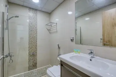 a bathroom with a sink and a shower at ShoresInn - Radiant 1BR in Dubai Marina in Dubai