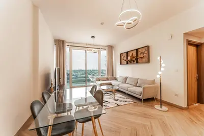 a living room with a glass table and a couch at Dubai Luxe Haven - World Record Residence in Dubai