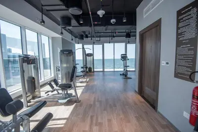 a gym with cardio equipment in a room with the ocean at Dubai Luxe Haven - World Record Residence in Dubai
