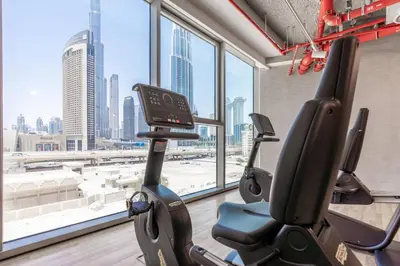 a gym with a view of a city at Stylish Burj khalifa view 5 Star 4BD Apartment in Downtown with Dubai Mall access - Brand New Apartment in Dubai