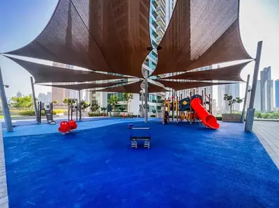 a playground with awning and play equipment on a blue carpet at Stylish Burj khalifa view 5 Star 4BD Apartment in Downtown with Dubai Mall access - Brand New Apartment in Dubai