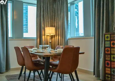 a dining room with a table and chairs at Luxury 2BR Suite I Garden View I Downtown Dubai in Dubai