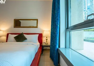 a bedroom with a bed and a window at Luxury 2BR Suite I Garden View I Downtown Dubai in Dubai