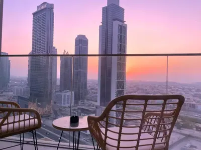 a view of a city skyline with a table and chairs at Luxury Stay at Forte Emaar - 5 Min Walk to Burj in Dubai