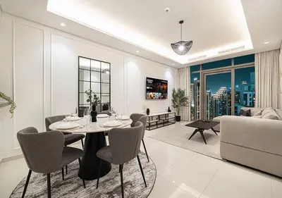a living room with a table and chairs and a couch at High Floor Apartment in 5 Star Hotel with Infinity Pool Burj View Gym Spa Sauna in Dubai
