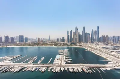 an aerial view of a marina with a city at 2BR Beachfront Apt with Stunning Dubai Marina View in Dubai