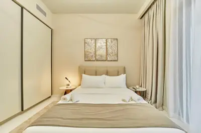 a bedroom with a large bed and a window at 2BR Beachfront Apt with Stunning Dubai Marina View in Dubai