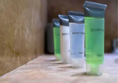 a row of bottles of body mist on a counter at Stylish 2BR I Partial Burj View I Downtown Dubai in Dubai
