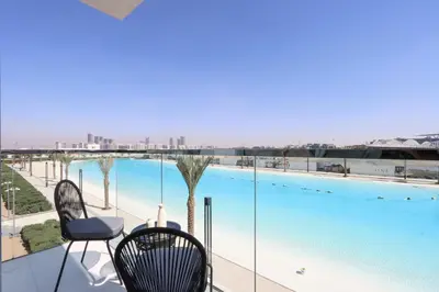 a balcony with a view of a swimming pool at Lagoonview 2BR District One in Dubai