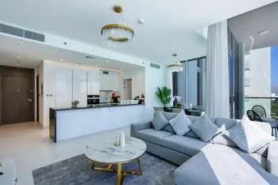 a living room with a couch and a table at Lagoonview 2BR District One in Dubai