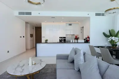 a living room with a couch and a table at Lagoonview 2BR District One in Dubai