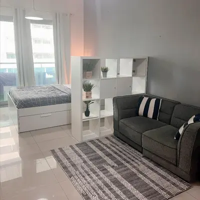 a living room with a couch and a bed at Studio with Sunset Views at Dubai Marina in Dubai