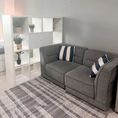 a living room with a couch and a rug at Studio with Sunset Views at Dubai Marina in Dubai