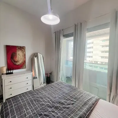 a bedroom with a bed and a large window at Studio with Sunset Views at Dubai Marina in Dubai