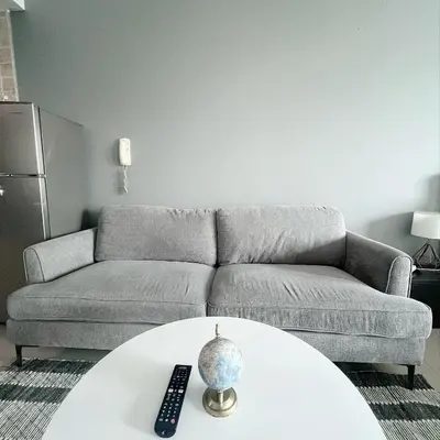 a living room with a couch and a table at Studio with Marina Breeze in Dubai