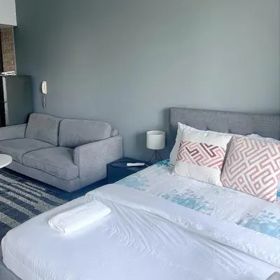 a bedroom with a bed and a couch at Studio with Marina Breeze in Dubai