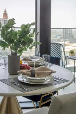 a dining room table with a plate of food on it at Frank Porter - The Address JBR in Dubai