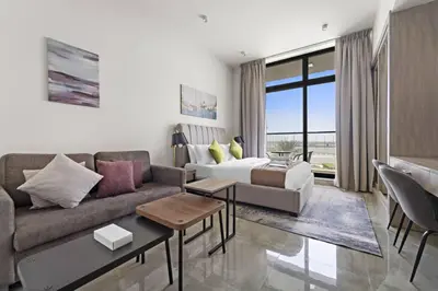a living room with a couch and a table at Luxury Studio Apartments at Majestique Residence in Dubai