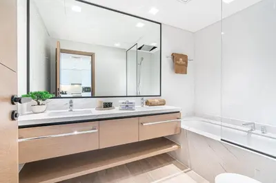 a bathroom with a sink and a mirror and a tub at Stunning Home in Palace Residences on 41st Floor in Dubai