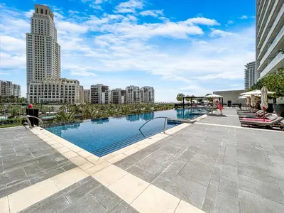 a large swimming pool in a city with tall buildings at Stunning Home in Palace Residences on 41st Floor in Dubai