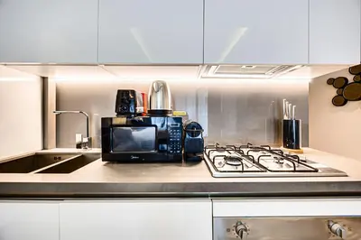 a microwave sitting on top of a kitchen counter at Cute studio in The Sterling by Omniyat in Dubai