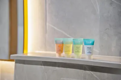 a row of four different colored moisturizers on a shelf at Bright Studio In Vibrant Dubailand District in Dubai
