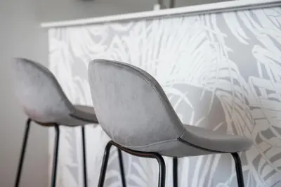 two gray chairs sitting next to a table at Bright Studio In Vibrant Dubailand District in Dubai