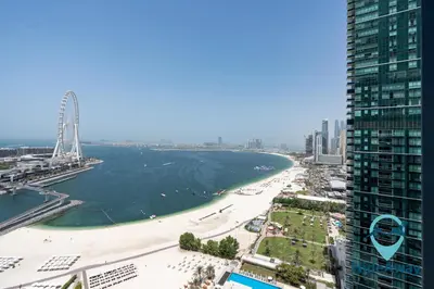 a view of a beach in front of a tall building at 3BR Best SeaView JBR Address Beach Resort in Dubai