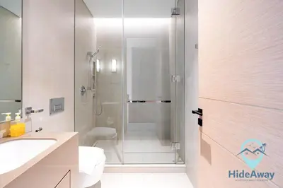 a bathroom with a shower and a toilet and a sink at 3BR Best SeaView JBR Address Beach Resort in Dubai