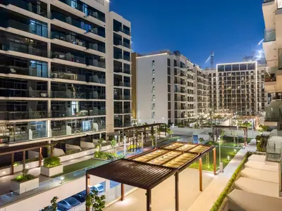 an aerial view of a building with tall buildings at Cozy 1BR with Pool View & Balcony in Dubai