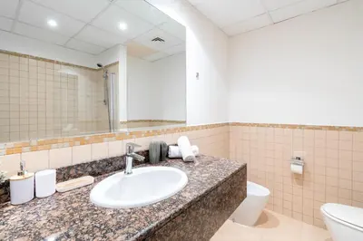 a bathroom with a sink and a toilet and a mirror at 1-BR Stunning Sea View Beachfront JBR in Dubai