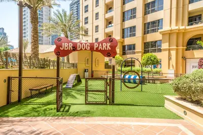 a park with a playground in front of a building at 1-BR Stunning Sea View Beachfront JBR in Dubai