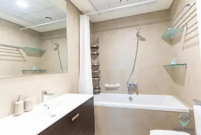 a bathroom with a tub and a sink at 2BR Stunning Luxury Heart of Marina Near Beach in Dubai