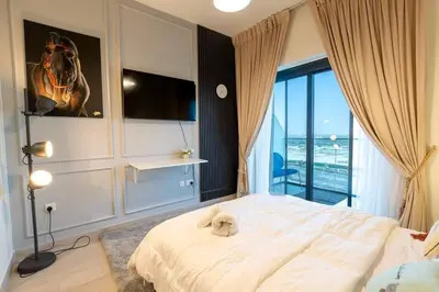 a bedroom with a bed with a stuffed animal on it at Cozy studio in Azizi Riviera with beautiful views in Dubai