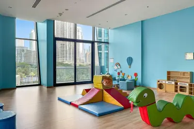 a childs room with a dinosaur themed play area at Luxury 2BR Burj View with Pool Walk to Mall & Metro Dining Shopping in Dubai