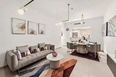 a living room with a couch and a table at Luxury 2BR Burj View with Pool Walk to Mall & Metro Dining Shopping in Dubai